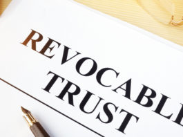 Revocable trust on a wooden desk.